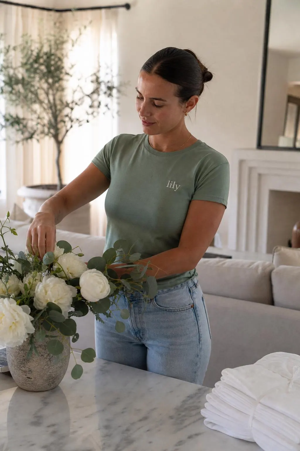 A Lily concierge arranging fresh flowers in a San Diego home